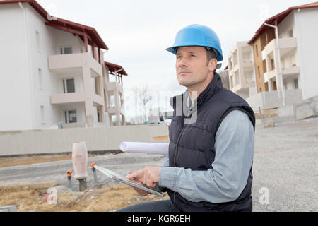 Supervisor using electronic tab on construction site Stock Photo
