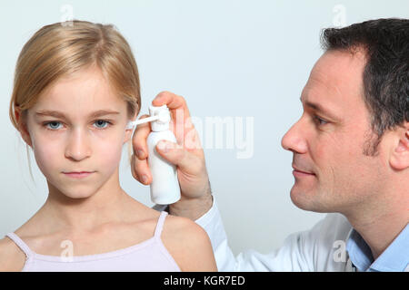 Doctor treating little girl ear infection Stock Photo