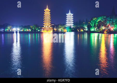 Guilin Sun and Moon Tower Pagodas in Fir Lake at night, color toned picture, China Stock Photo