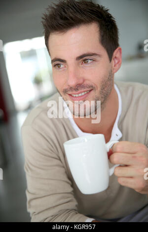 Young man at home drinking coffee Stock Photo