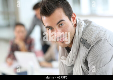 Portrait of smiling student guy in class Stock Photo