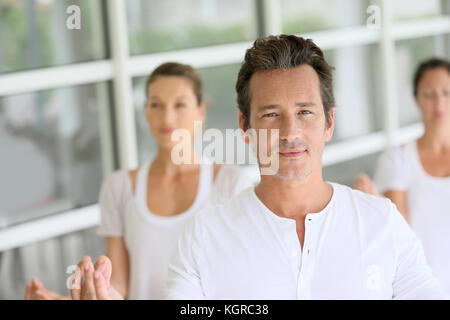 Mature man amongst group doing yoga exercises Stock Photo - Alamy