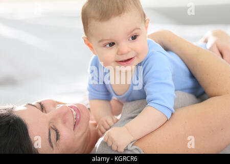Portrait of mother cuddling baby boy Stock Photo