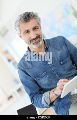 Teacher using tablet in university class Stock Photo