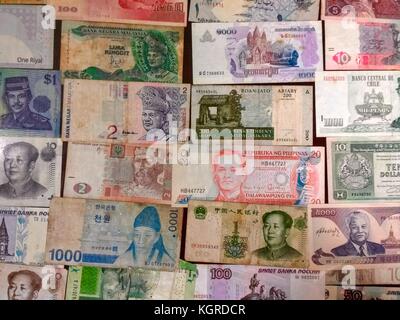 Close up of many different used banknotes from around the world placed side by side to fill photo Stock Photo