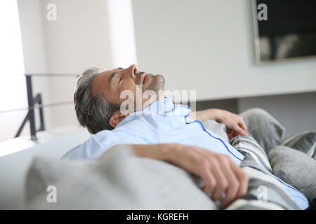 Middle-aged man having a restful moment relaxing in sofa Stock Photo