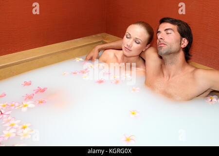 Couple relaxing in spa milk bath Stock Photo