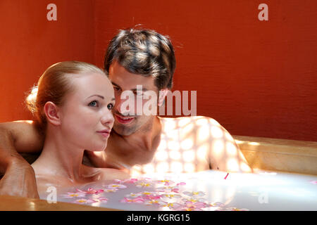 Couple relaxing in spa milk bath Stock Photo