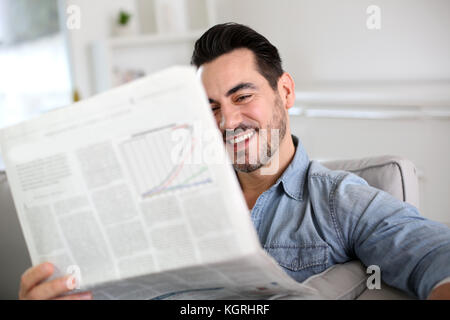 Man relaxing at home with newspaper Stock Photo