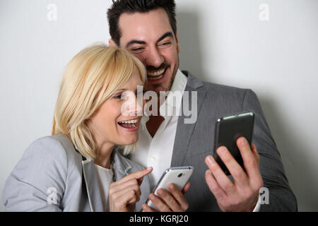 Couple using smartphone together Stock Photo