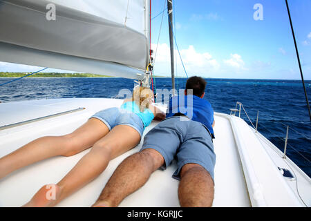 Couple relaxing on a sailing boat while cruising Stock Photo