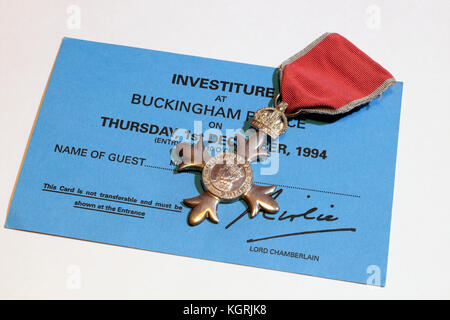 Investiture at Buckingham Palace invitation, and MBE medal member of the British empire life event honours system award Stock Photo