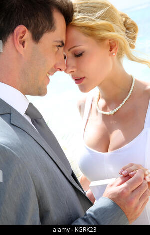 Bride and groom exchanging wedding rings Stock Photo