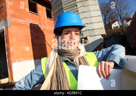 Architect on building site using electronic tablet Stock Photo