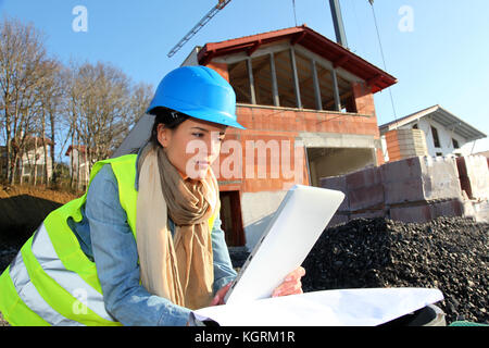 Architect on building site using electronic tablet Stock Photo
