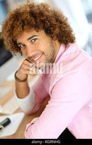 Young man in office working on desktop computer Stock Photo