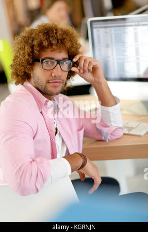 Young man in office working on desktop computer Stock Photo