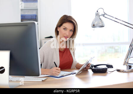 Businesswoman in office working with tablet