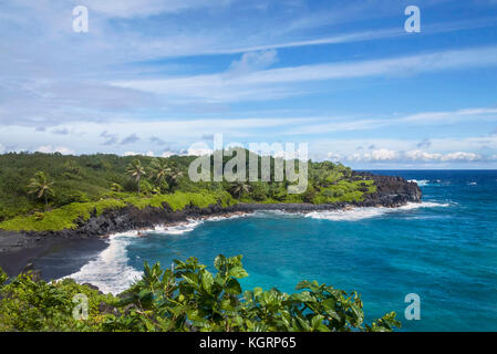 Waiʻanapanapa State Park located in the town of Hana, Hawaii feature beautiful volcanic black sand beaches and gorgeous coastline hiking trails that l Stock Photo