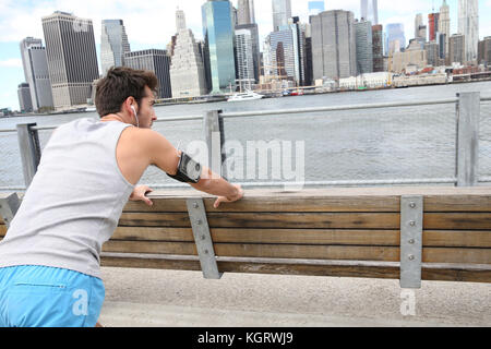 Man stretching out after training on Brooklyn Heights promenade Stock Photo