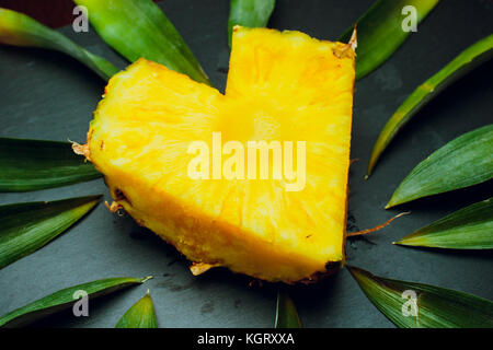 isolated on a black background fresh pineapple leaves love fruit Stock Photo