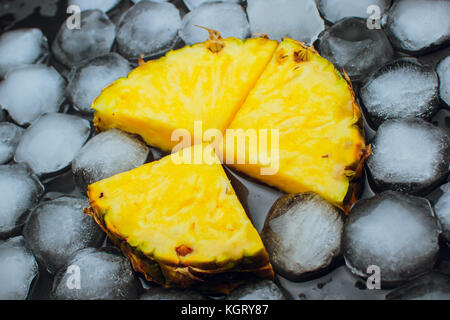 on a black background fresh pineapple ice fruit Stock Photo