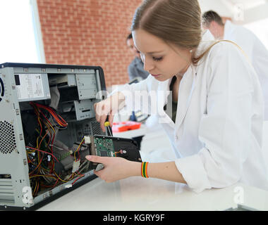Student girl in technology fixing computer hard drive Stock Photo