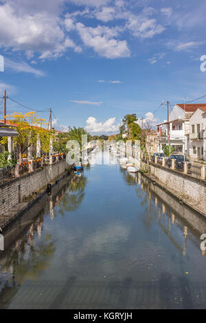 CORFU, GREECE- NOVEMBER 09, 2017: The channel that floats through Lefkimmi in the southern part of Corfu, Greece.Fishing boats and coffee shops either Stock Photo