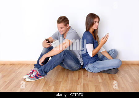 Young people sending messages with mobile phone Stock Photo