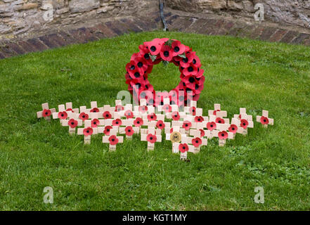 Remembrance Day Poppy Wreath and crosses in a town churchyard. Stock Photo