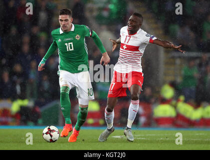 Northern Ireland's Kyle Lafferty (left) and Switzerland's Denis Zakaria battle for the ball during the 2018 World Cup Qualifying Play-Off, First Leg match at Windsor Park, Belfast. Stock Photo