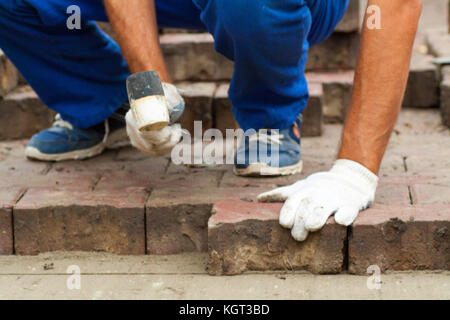 Laying Paving Slabs by mosaic close-up. Stock Photo