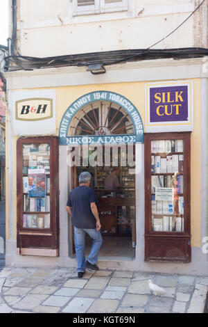Man entering tobacconists shop in Old Corfu town, Greece Stock Photo