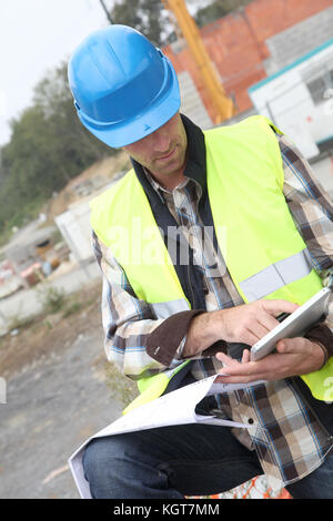 Construction manager using electronic tablet on site Stock Photo