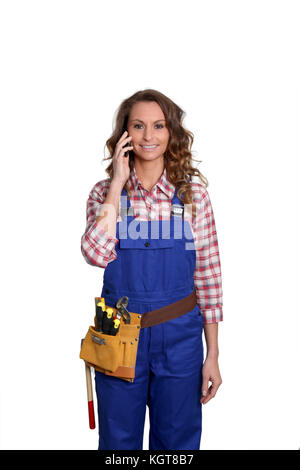 Woman carpenter standing on white background Stock Photo