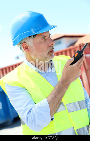 Site manager using walkie-talkie Stock Photo