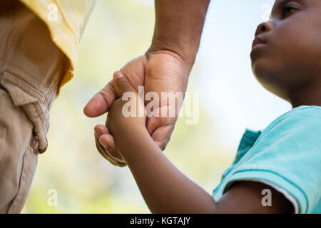 Father holding his his sons hand. Stock Photo