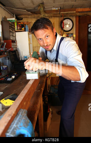 Joiner working wood in workshop Stock Photo