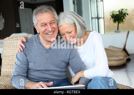 Happy senior couple connected on internet at home Stock Photo