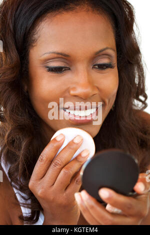 Beautiful mature woman applying makeup. Stock Photo