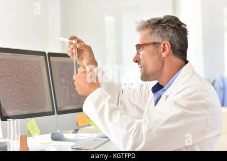 Microbiologist in office working on sample Stock Photo