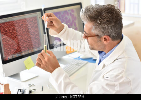 Microbiologist in office working on sample Stock Photo