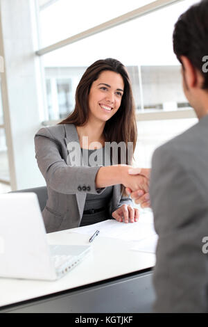 Business partners shaking hands after meeting Stock Photo