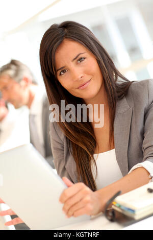 Beautiful businesswoman using electronic tablet Stock Photo