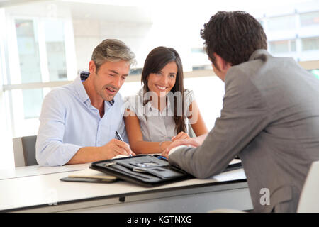 Father and teenager signing loan contract Stock Photo