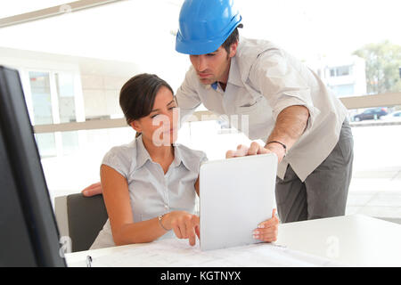 Architects working in office with electronic tablet Stock Photo