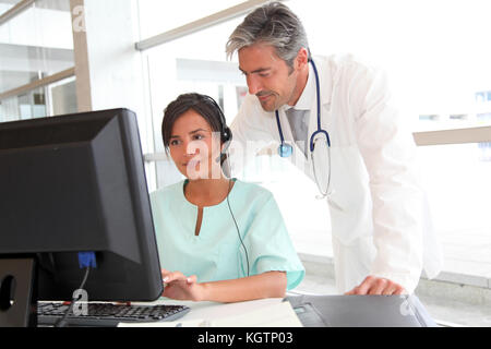Doctor and nurse working in office Stock Photo