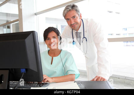 Doctor and nurse working in office Stock Photo