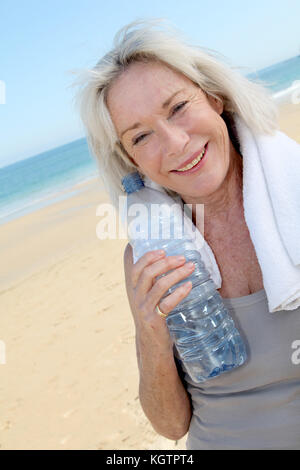 Portrait of senior woman drinking water Stock Photo