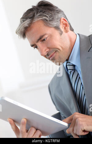 Portrait of businessman using electronic tablet Stock Photo